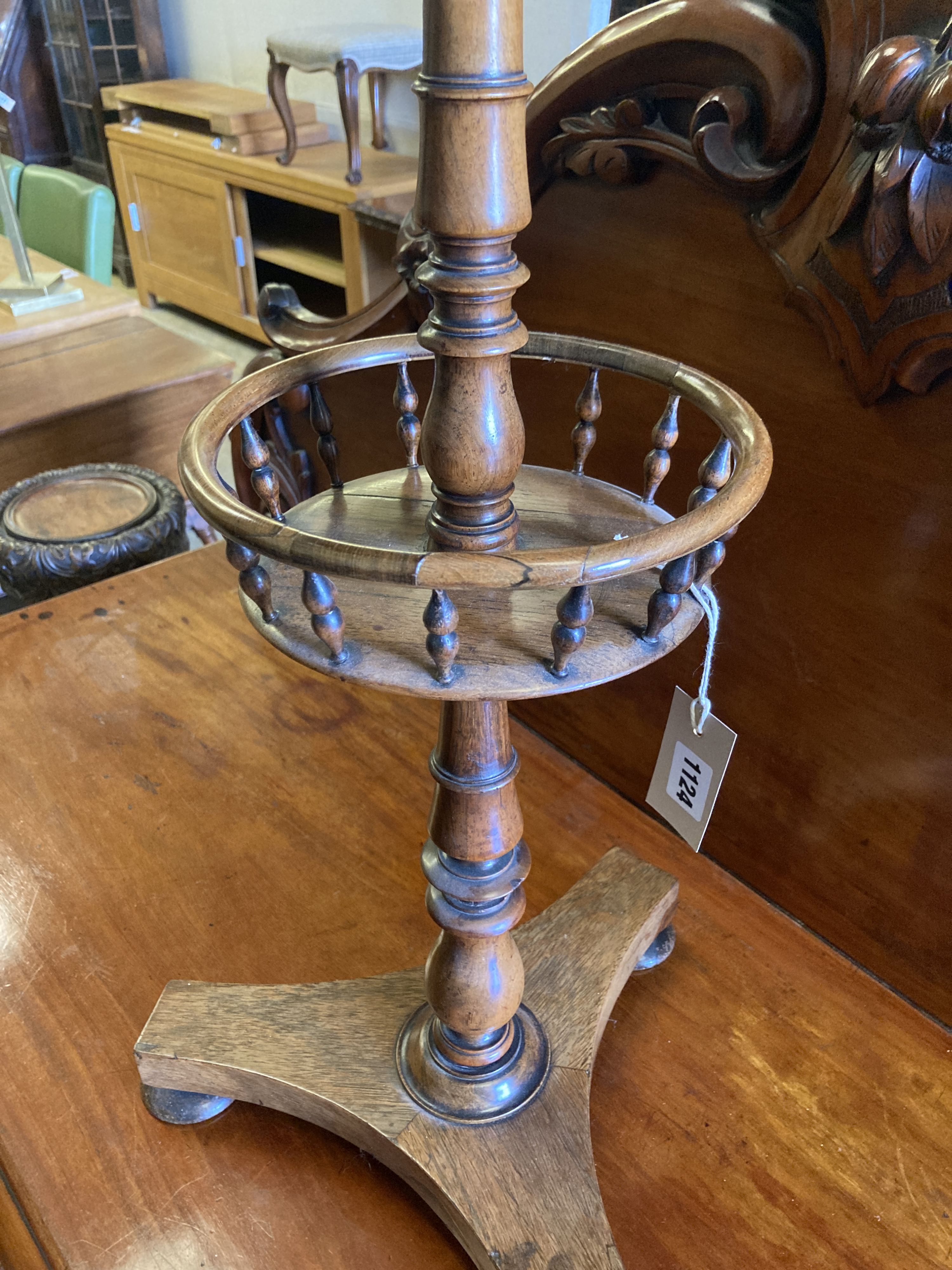 An early Victorian circular rosewood candlestand with galleried shelf on platform base, diameter 35cm, height 72cm
